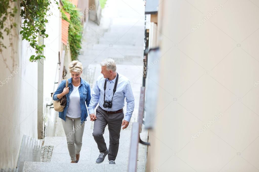 middle-aged couple holding hands