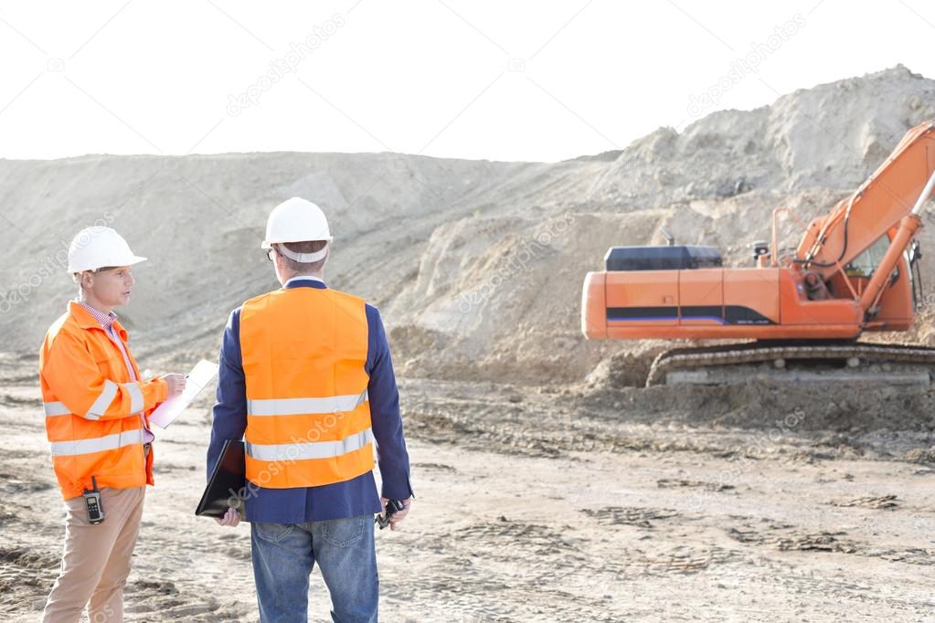 Supervisors standing at construction site