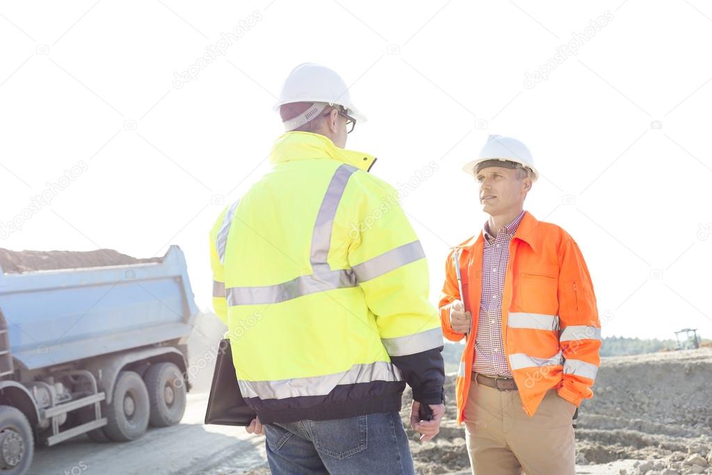 Engineers discussing at construction site