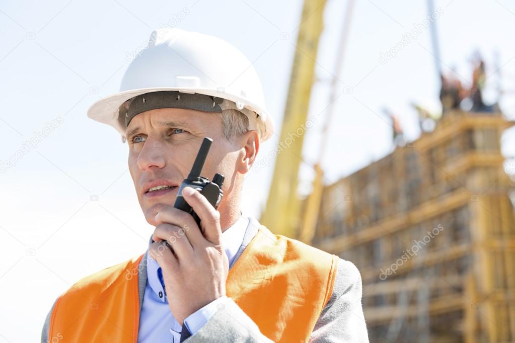 Confident supervisor using walkie-talkie