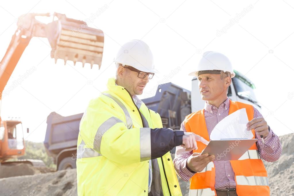 Engineers discussing over documents