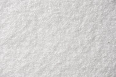 Macro image of white felt fabric, highlighting its soft, fuzzy surface texture, ideal for backgrounds or textile visuals.