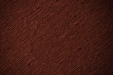 Macro closeup of dark brown woven fabric showing fine diagonal weave and soft texture.