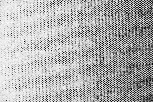 Крупным планом на белой бумаге изображена полукруглая полукруглая фигура из плотно расположенных черных точек, демонстрирующих плавную тональную вариацию и текстуру печати.