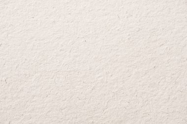 Yumuşak, lifli dokusu ve doğal düzensizlikleri olan beyaz el yapımı kağıdın makro görüntüsü..