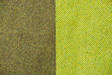 Yarım tonluk bir dokunun makrosu, farklı bir renk değişimini gösteriyor, yeşilden parlak sarıya, desenli kağıda cyan noktalar basılmış..