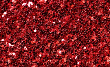 Işıldayan kırmızı ışıldayan parçacıkların yakın çekimi zengin ışık yansımalarıyla neşeli, ışıl ışıl bir zemin oluşturuyor..