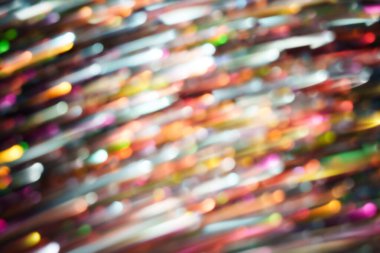 Renkli köşegen ışık çizgileri yumuşak hareket bulanıklığı ve koyu bir arkaplanda parlayan gölgeler. Teknoloji, hız, müzik, gece hayatı ve modern tasarım için dinamik soyut arkaplan.