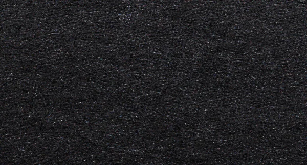 Makro yakın plan siyah baskılı mürekkep kağıdı görünür lifler, buğday ve benekli baskı dokusu ile. Grunge arkaplan, editoryal tasarım ve retro yazdırma için ideal.