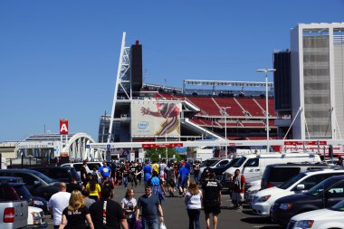 People walking through parking lot to arena clipart