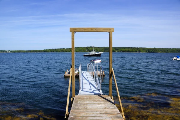 Pier leading to the water with boats in the distance on Littlejo — Stock Photo, Image