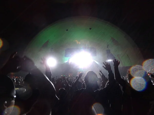 Shaggy sings on stage in the rain as crowd dances and waves hand — Stock Photo, Image