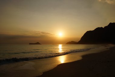 Early Morning Sunrise on Waimanalo Beach over Rock Island bursti clipart