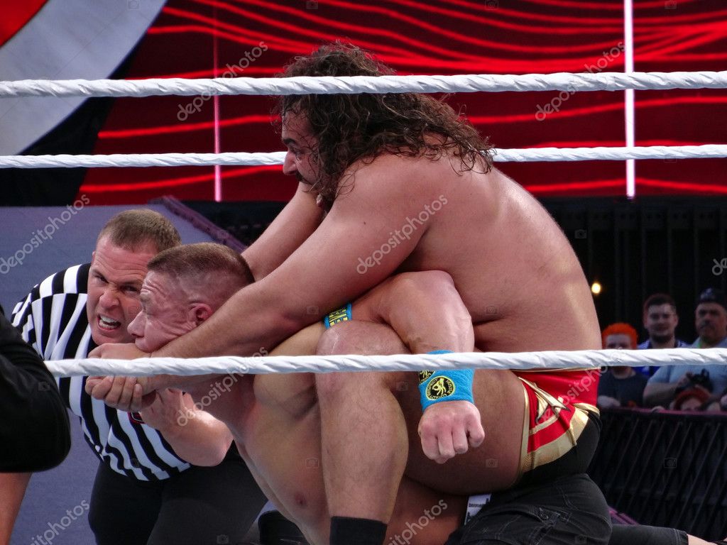 SANTA CLARA - MARCH 29: WWE Wrestler Rusev puts John Cena in The Accolade with ref checking in during wrestling match for USA Championship title match at Wrestlemania 31 at the Levi's Stadium in Santa Clara, California on March 29, 2015.