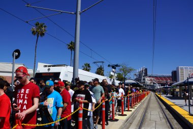 Crowd of people de-board VTA transit train to attend Wrestlemani clipart