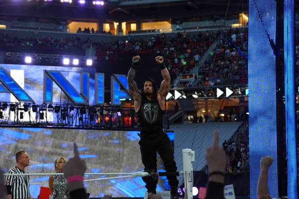 Roman Reigns wrestler stands on top turnbuckle with arms in the — Stok fotoğraf