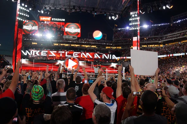 Ref raises Seth Rollins arms as he celebrates with fans victory — ストック写真
