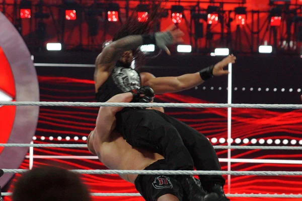 WWE Champion Brock Lesner suplexes Roman Reigns who waves arms i — Stock Photo, Image