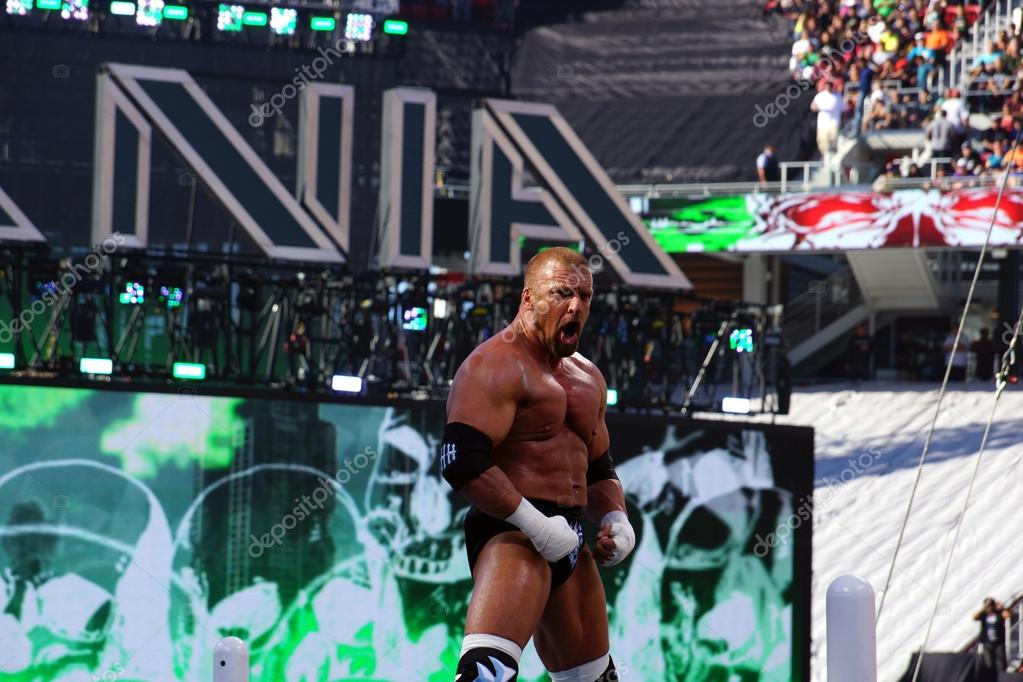SANTA CLARA - MARCH 29: Triple H flexes muscles as he stands on top of turnbuckles looking out into crowd before match at Wrestlemania 31 at the Levi's Stadium in Santa Clara, California on March 29, 2015.
