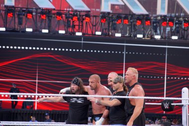 Triple H holds sledgehammer and Sting holds bat in ring during m