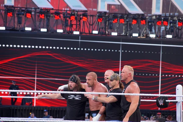 Triple H holds sledgehammer and Sting holds bat in ring during m Ліцензійні Стокові Фото