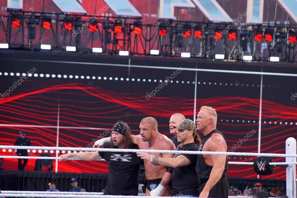 SANTA CLARA - MARCH 29: Triple H holds members of DX, X-Pac, Shawn Michaels, Billy Gunn, and Road Dogg Jesse James in the ring after match at Wrestlemania 31 at the Levi's Stadium in Santa Clara, California on March 29, 2015.