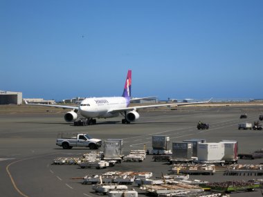 Hawaiian Airlines airplanes taxis out to runway as it prepares f