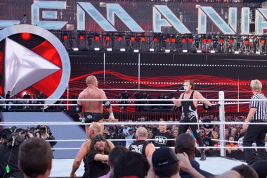 Triple H holds sledgehammer and Sting holds bat in ring during m