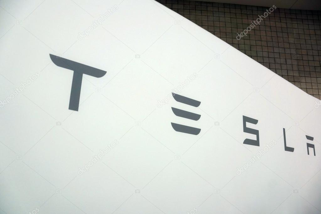 HONOLULU - MARCH 14, 2015: White Tesla sign with grey text at the Motor Show exhibition - 2015 First Hawaiian International Auto Show at the Convention Center in Oahu, Hawaii.  March 14, 2015.