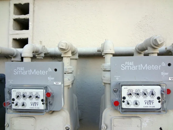 Two PG&E (utility co)  electricity SmartMeters on residential bu — Stock Photo, Image