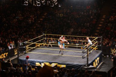WWE NXT Superstar Kalisto puts sleeper hold on wrestler Solomon clipart