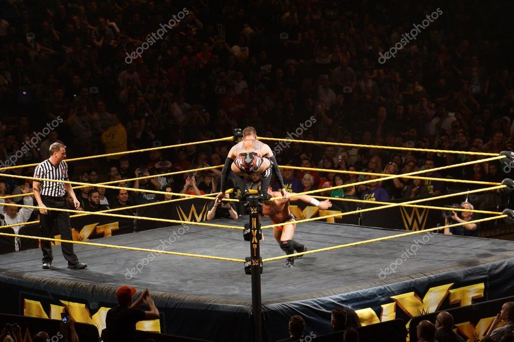 SAN JOSE - MARCH 27: NXT male wrestler Finn Balor squats on top of ring ropes as Adrian Neville across ring towards him during match at the San Jose Event Center in San Jose, California on March 27, 2015.