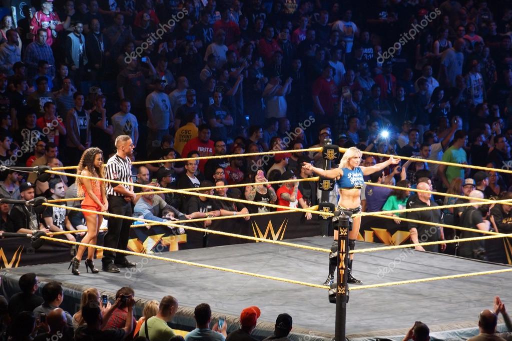 SAN JOSE - MARCH 27: NXT Female wrestlers Charlotte Flair stands in ring with arms extended before for divas championship match at the San Jose Event Center in San Jose, California on March 27, 2015.