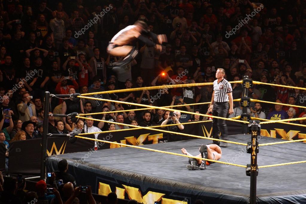 SAN JOSE - MARCH 27: NXT male wrestler Finn Balor does Coup de Grace (Diving double foot stomp) off top rope with Adrian Neville laying on mat below during match at the San Jose Event Center in San Jose, California on March 27, 2015.