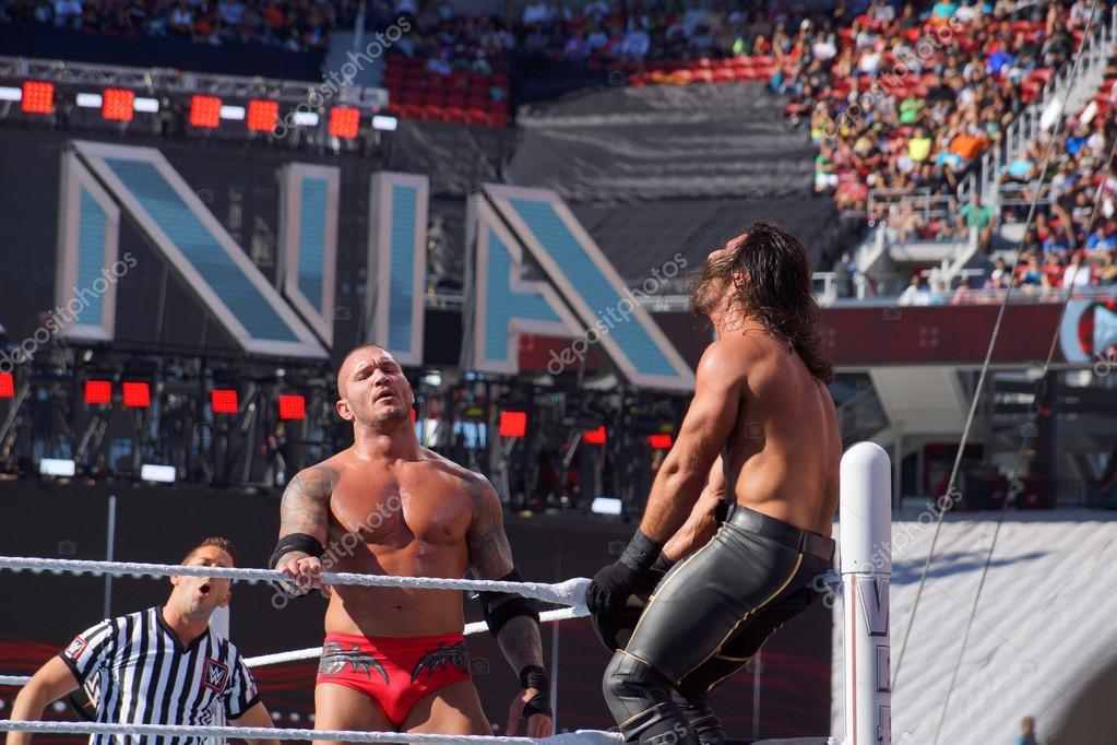 SANTA CLARA - MARCH 29: WWE Wrestler Seth Rollins gets crouched in top turnbuckle as Randy Orton stands looking into crowd during match at Wrestlemania 31 at the Levi's Stadium in Santa Clara, California on March 29, 2015.