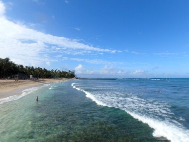 Waves roll to shore at Queens Beach in Waikiki