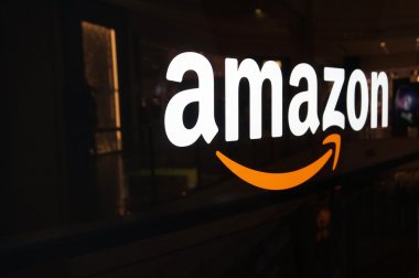 Amazon logo on black shiny wall in San Francisco mall