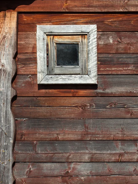 Wooden barn wall with a small window — Stock Photo, Image