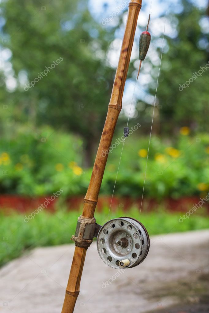 Old fishing rod on nature background — Stock Photo © Koldunov #117511452