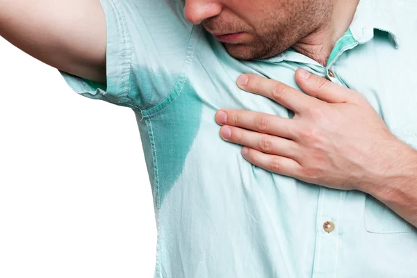 Young man in horror looking at the sweaty shirt — Stock Photo, Image