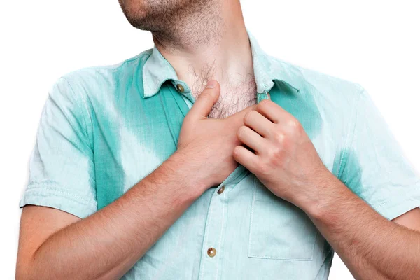 Young man in horror looking at the sweaty shirt — Stock Photo, Image