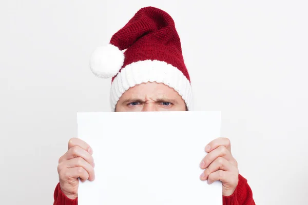 Disgruntled Santa Claus holding a blank plate — Stock Photo, Image