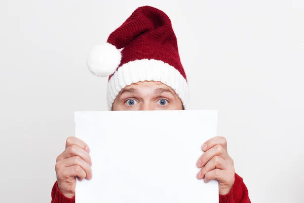 Surprised Santa Claus holding a blank plate — Stock Photo, Image