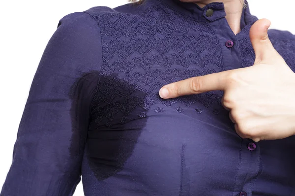 Young woman looking at the sweaty shirt — Stock Photo, Image