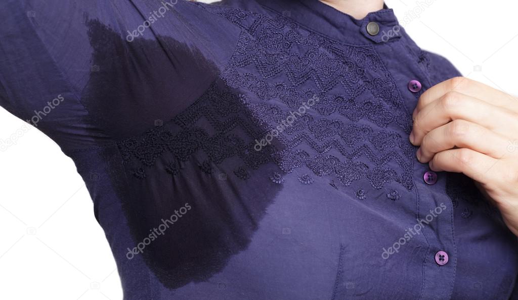 Young woman looking at the sweaty shirt