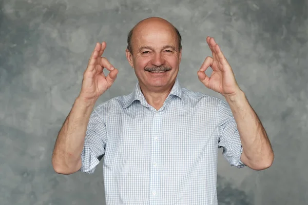 Senior man with mustache showing OK sign approving your choice — Stock Photo, Image