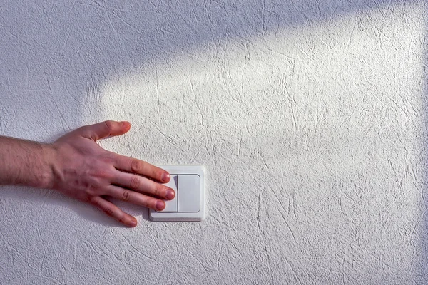 Turning light switch. Saving electricity. — Stock Photo, Image