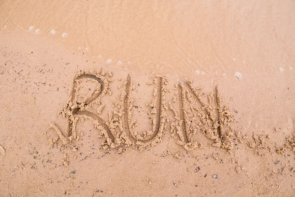 Inschriften auf dem Sand: run — Stockfoto