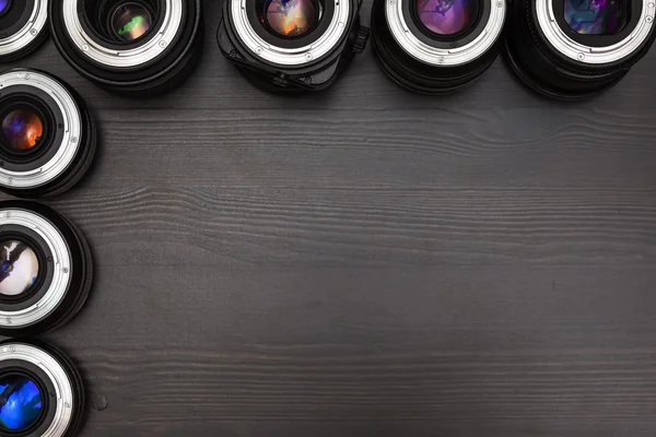 A lot of expensive photo lenses with colorful reflection as a background — Stock Photo, Image