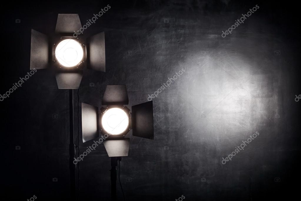 Lighting equipment on a black background old shabby wall — Stock